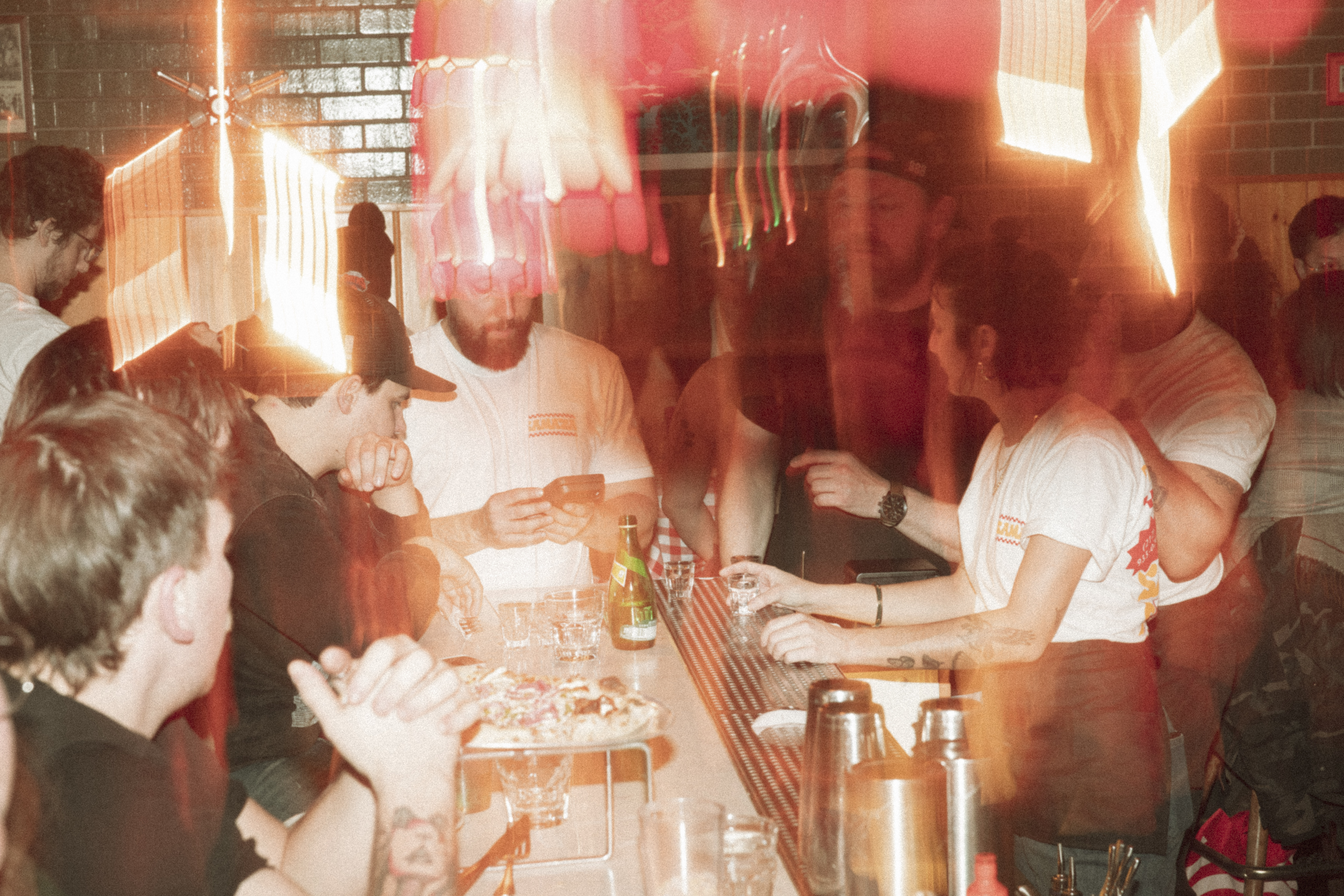 a group of people sitting at a bar