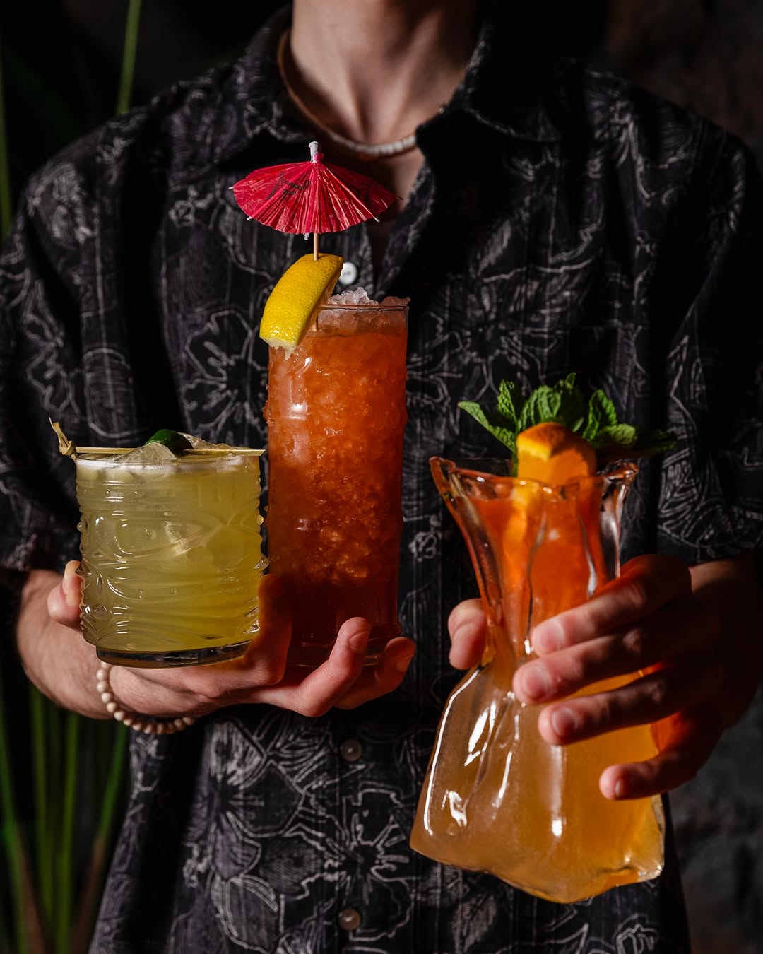 a person holding drinks in their hands