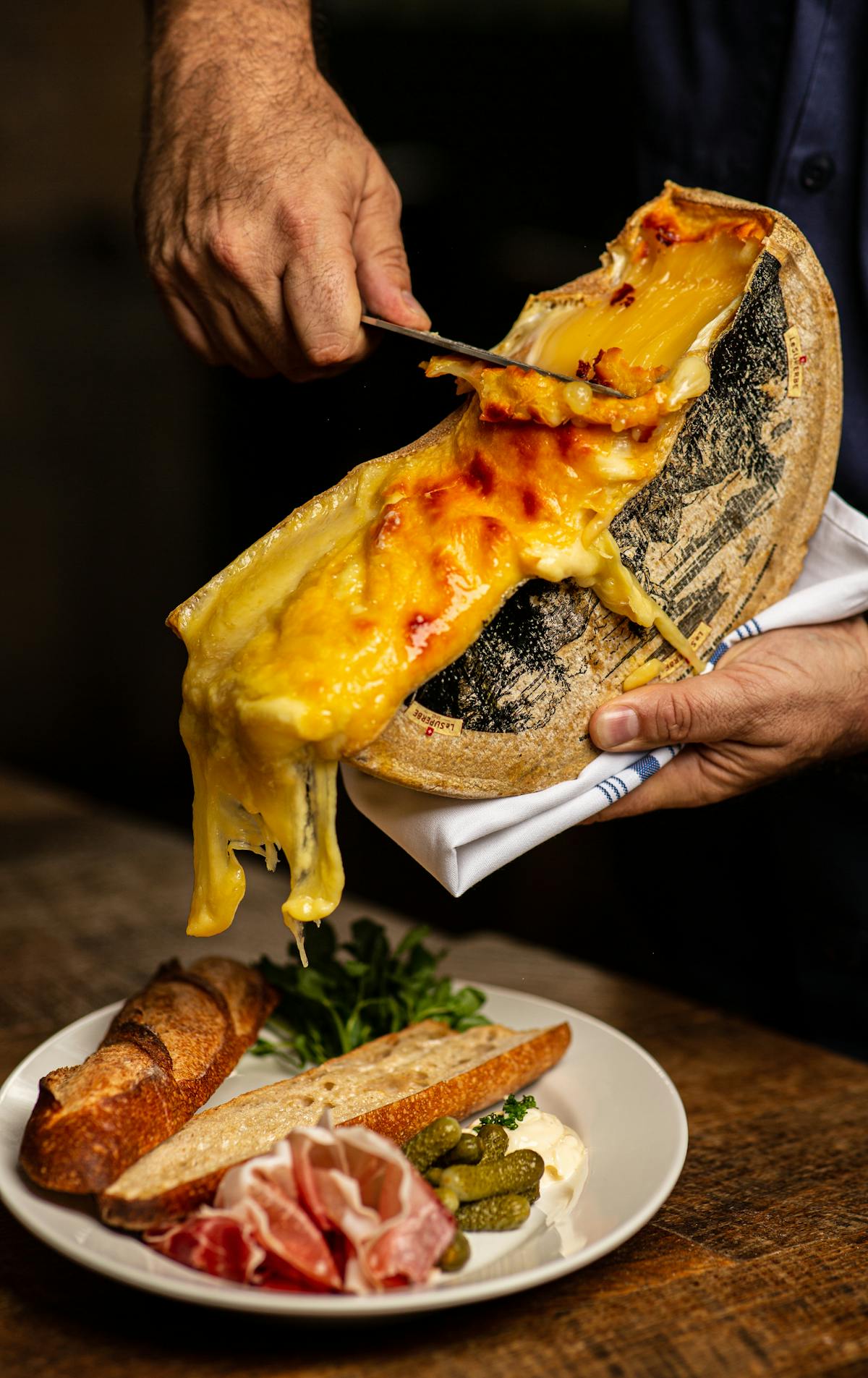 a hand holding a slice of pizza on a plate