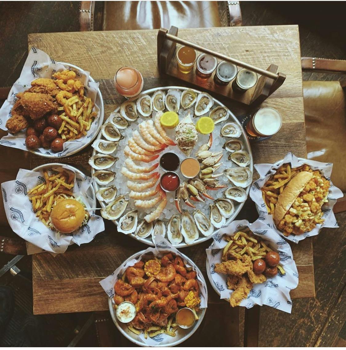 a wooden table topped with different types of food on a plate