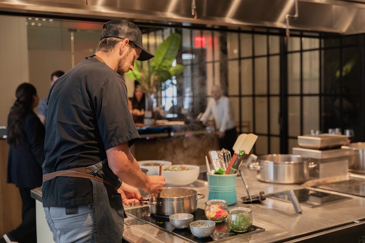 a man cooking in a kitchen preparing food