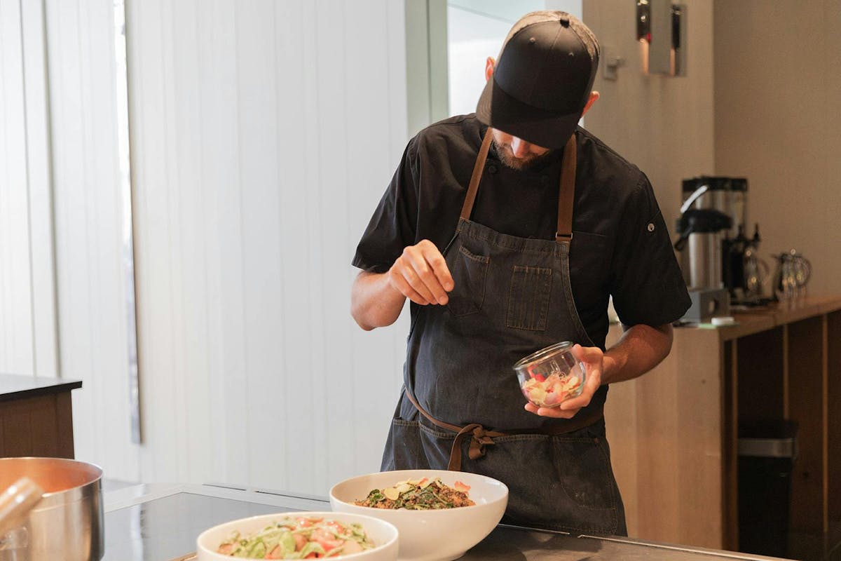 a person holding a slice of pizza
