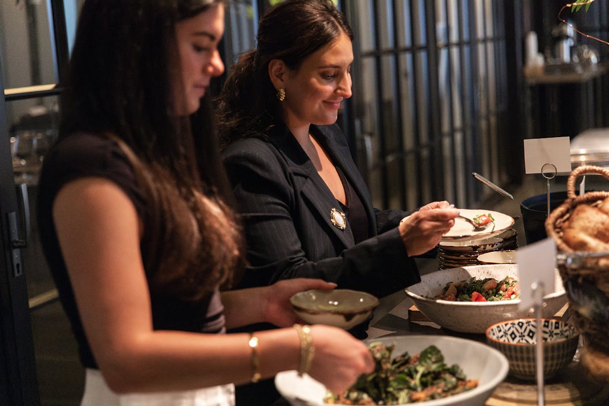 a woman sitting at a table with a plate of food