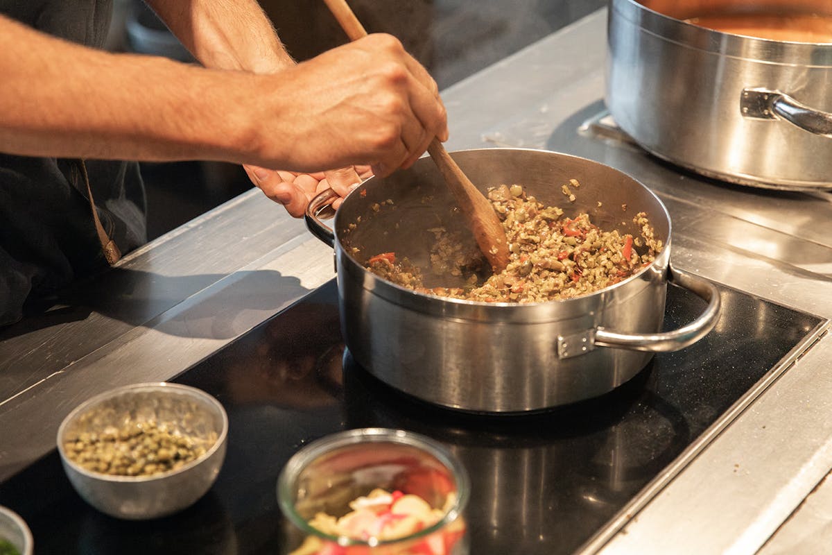 a person cooking food on a stove