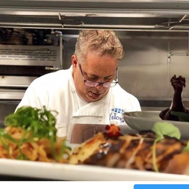 a man standing in front of a plate of food