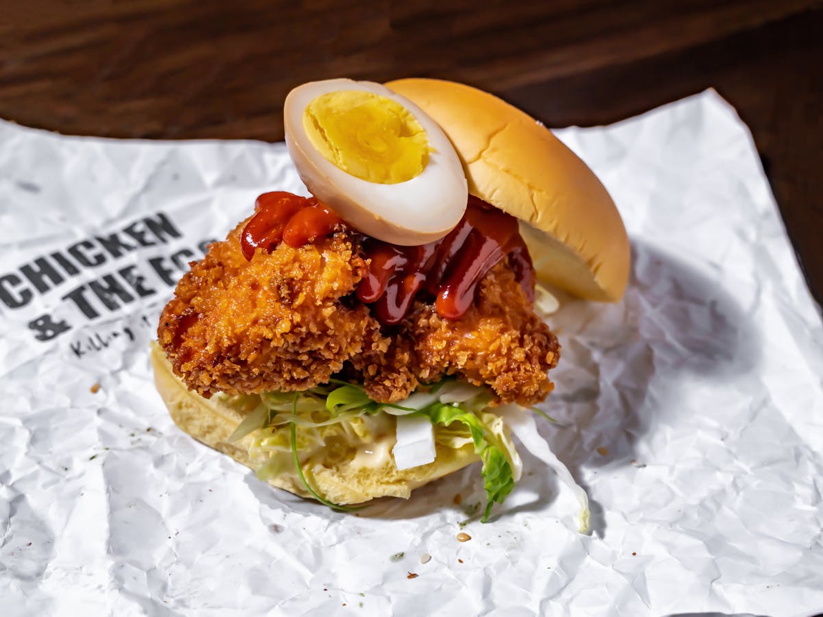 an chicken and egg sandwich sitting on top of a table
