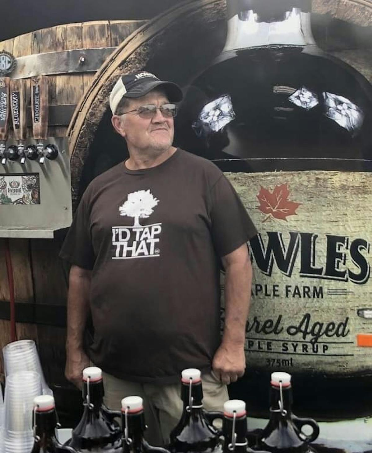 a man standing in front of a barrel