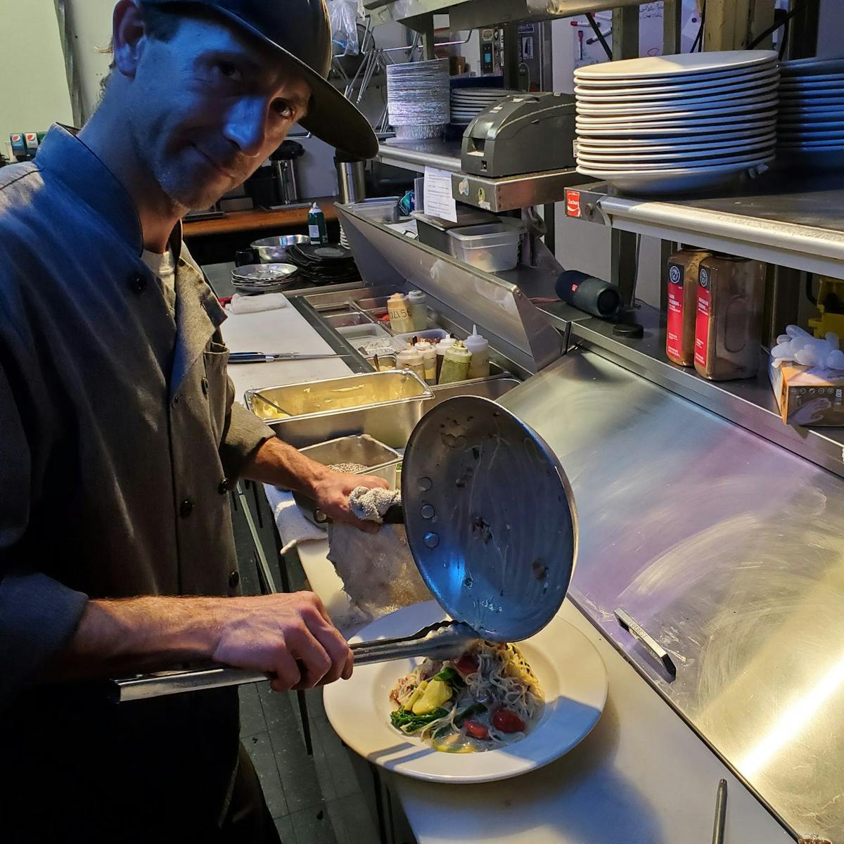 a man cooking in a kitchen preparing food