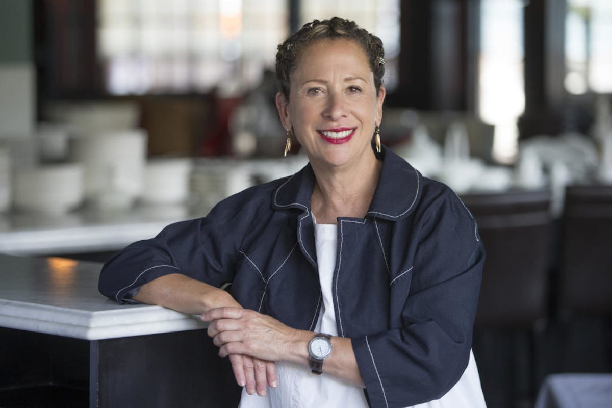 Nancy Silverton sitting at a table