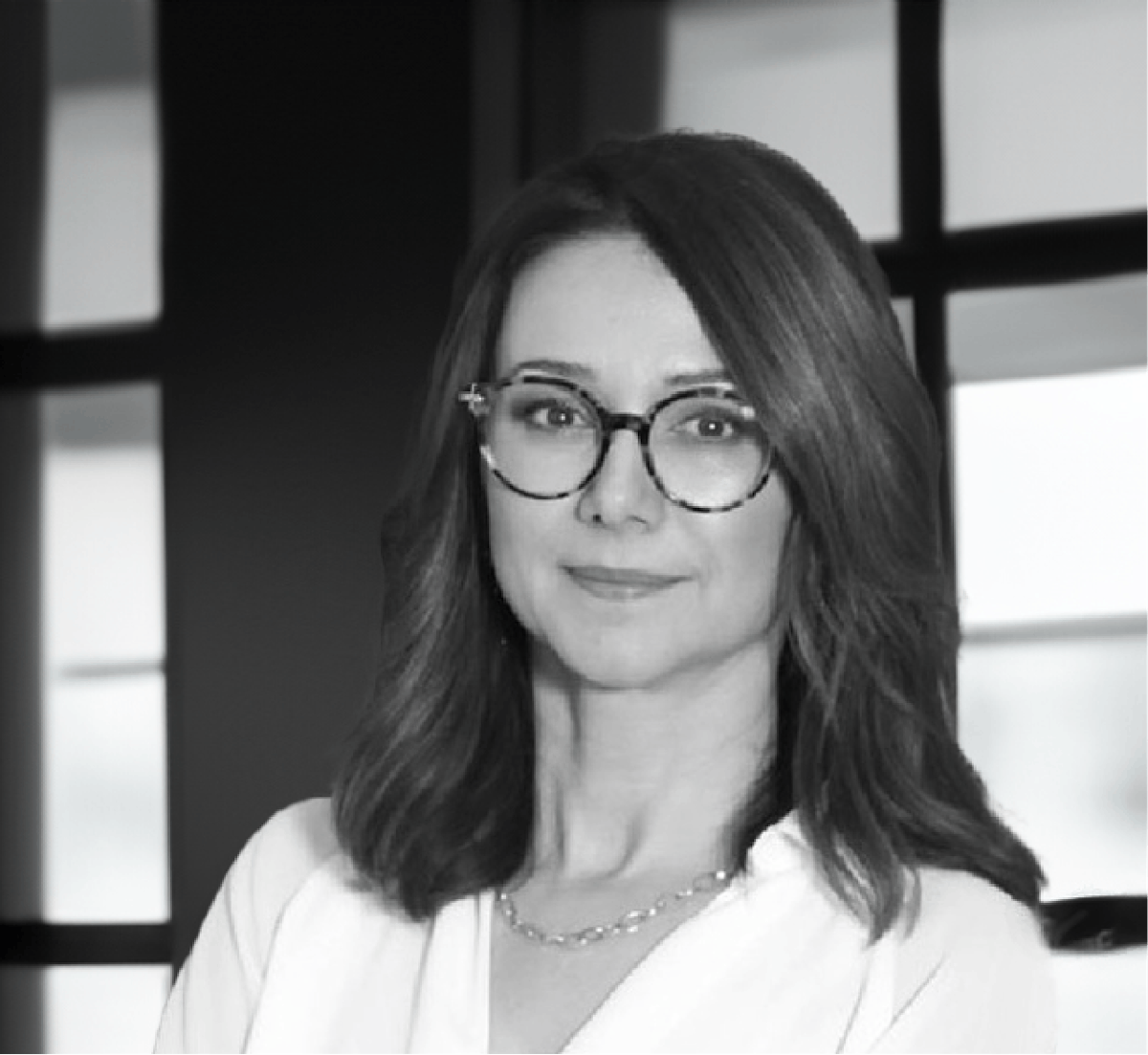 a person in glasses looking at the camera