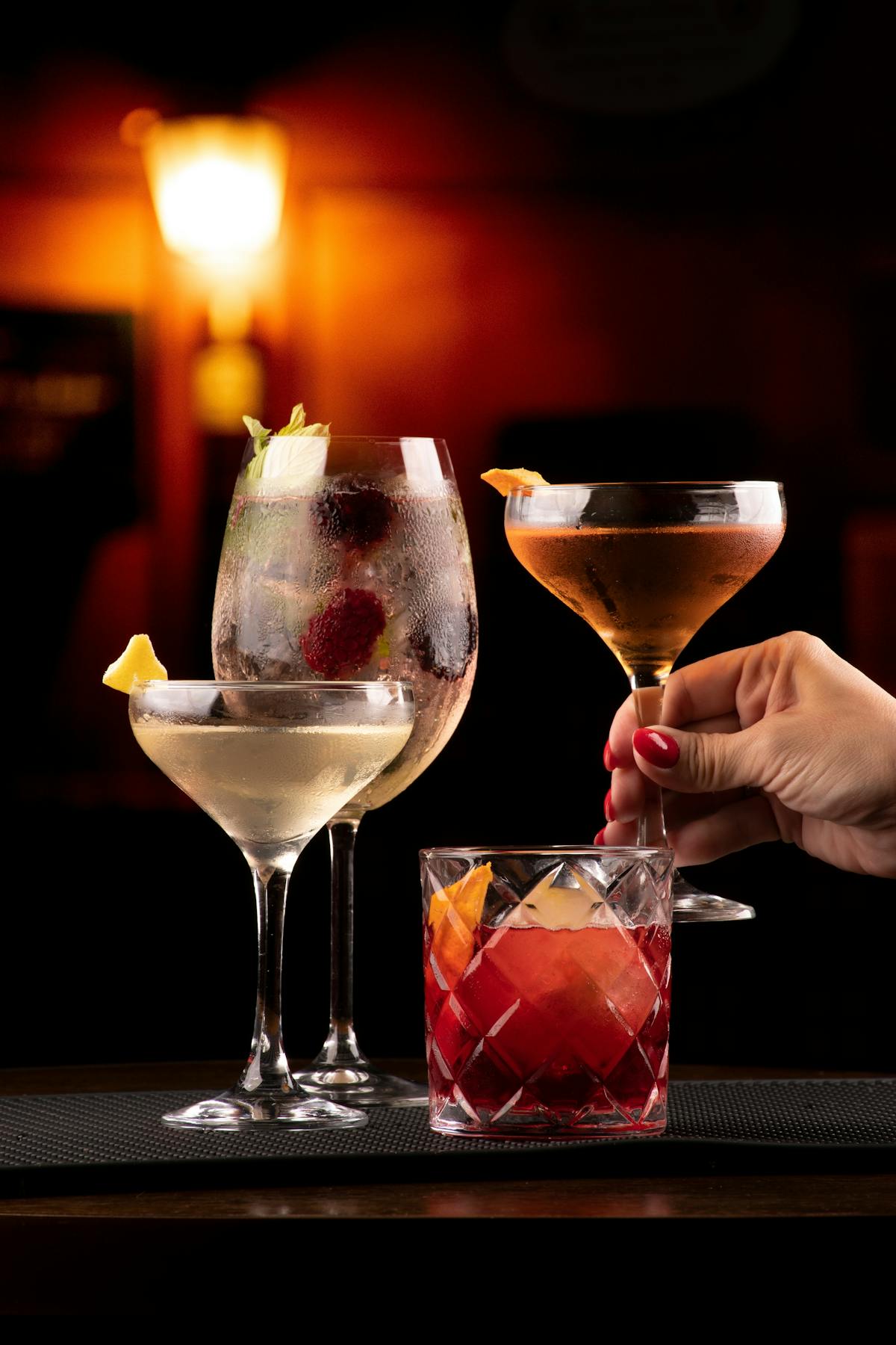 Several cocktails are staged on a bar