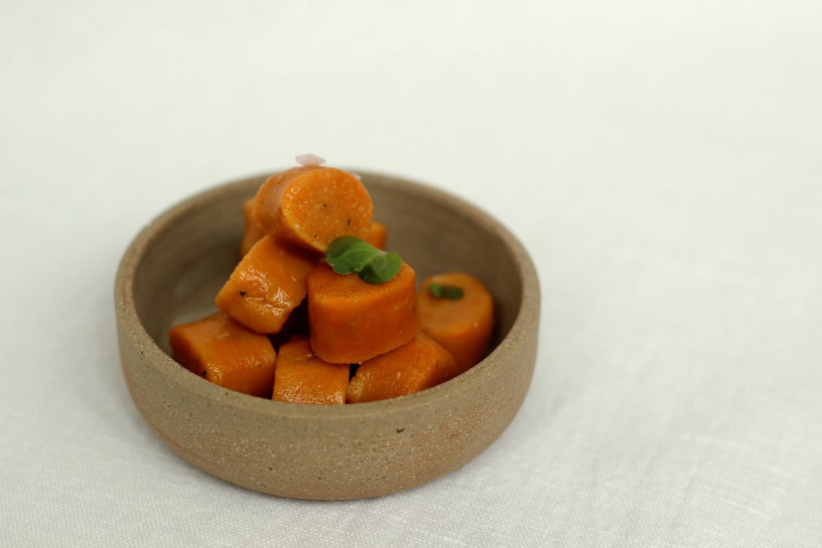 a bowl of oranges on a table