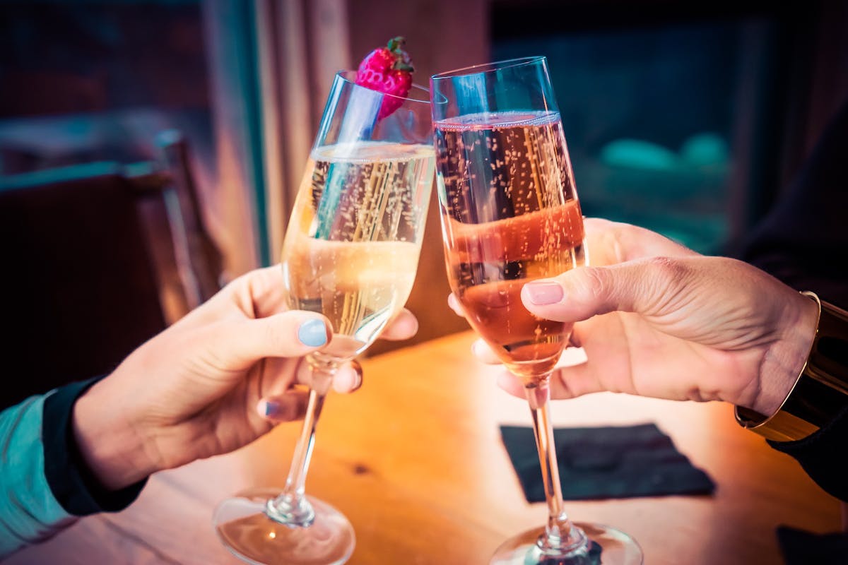 a hand holding a glass of wine
