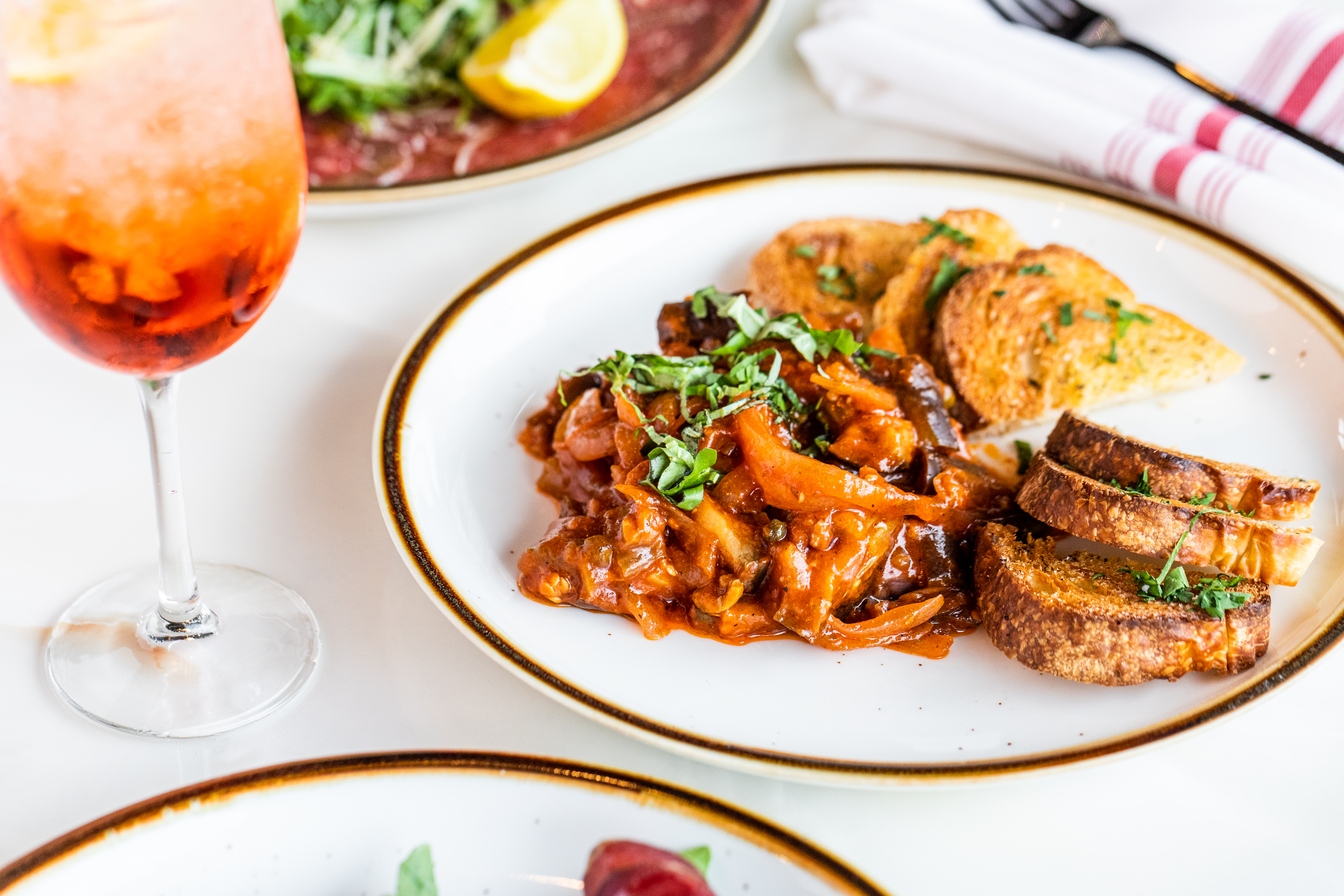 a plate of food and a glass of wine