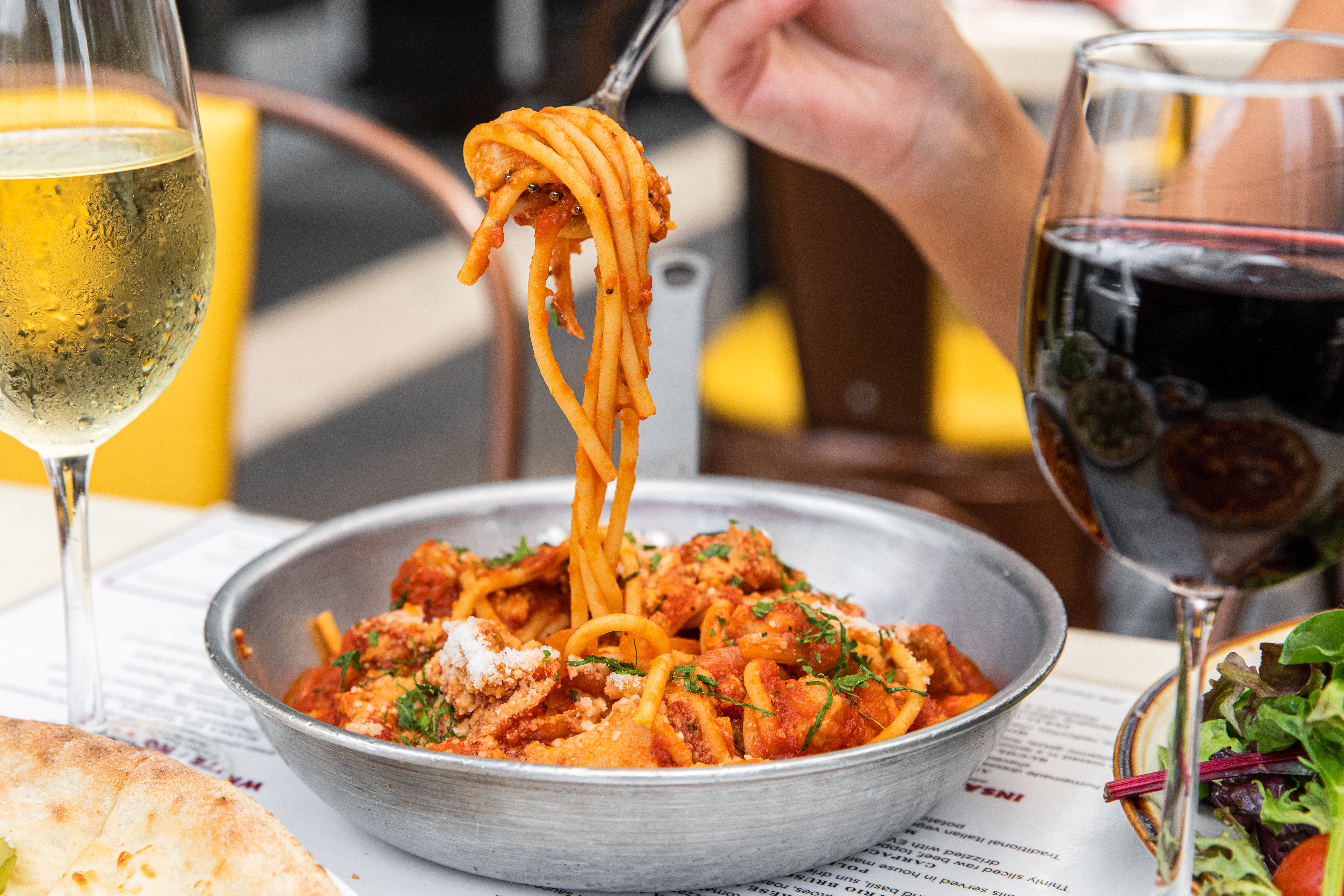a plate of food and glasses of wine on a table