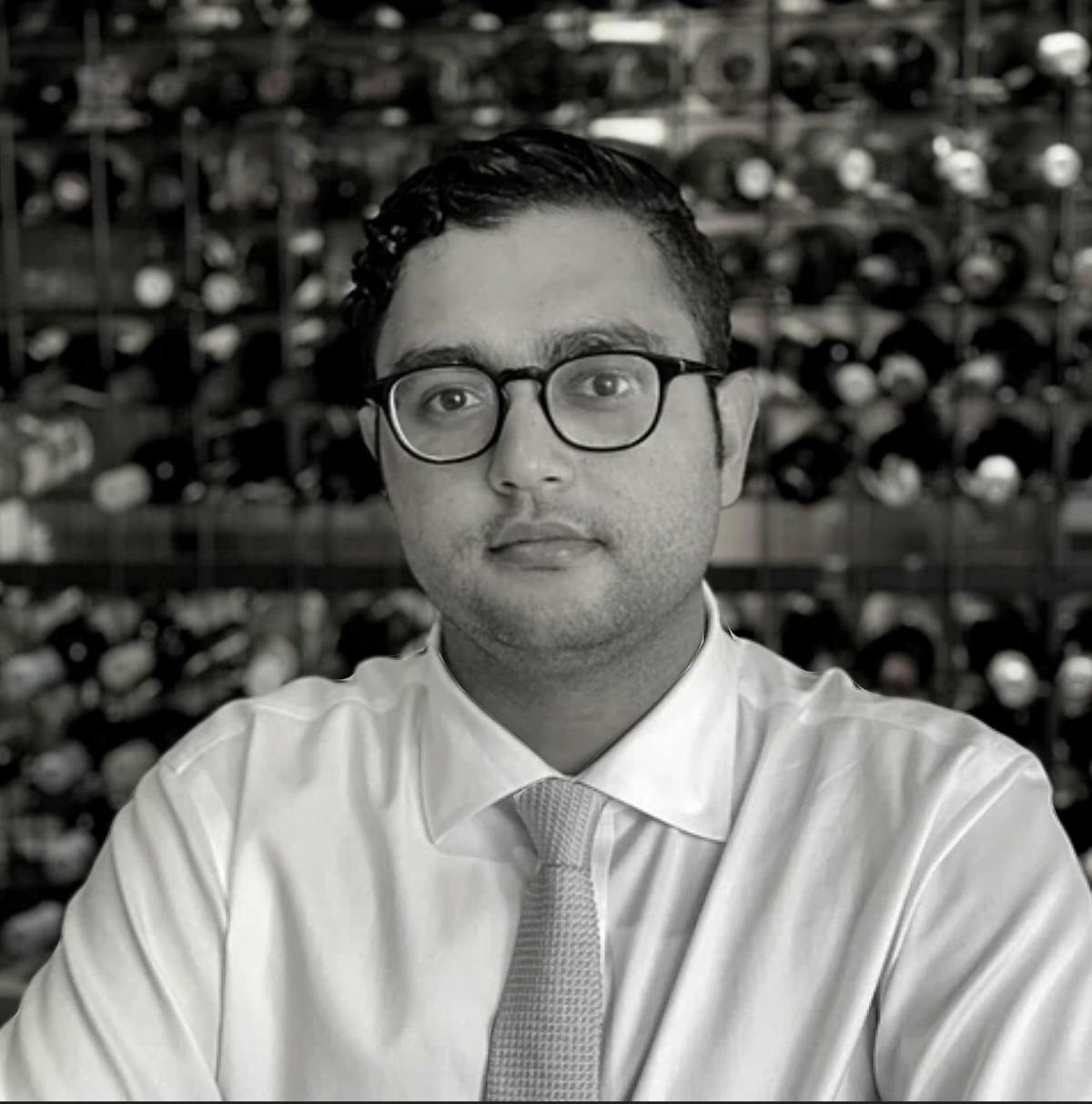 a man wearing glasses posing for the camera