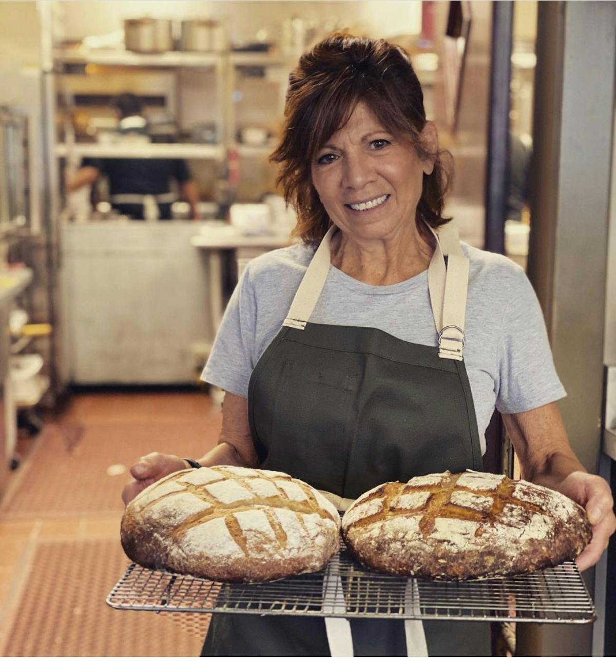 a woman standing in front of a plate of food
