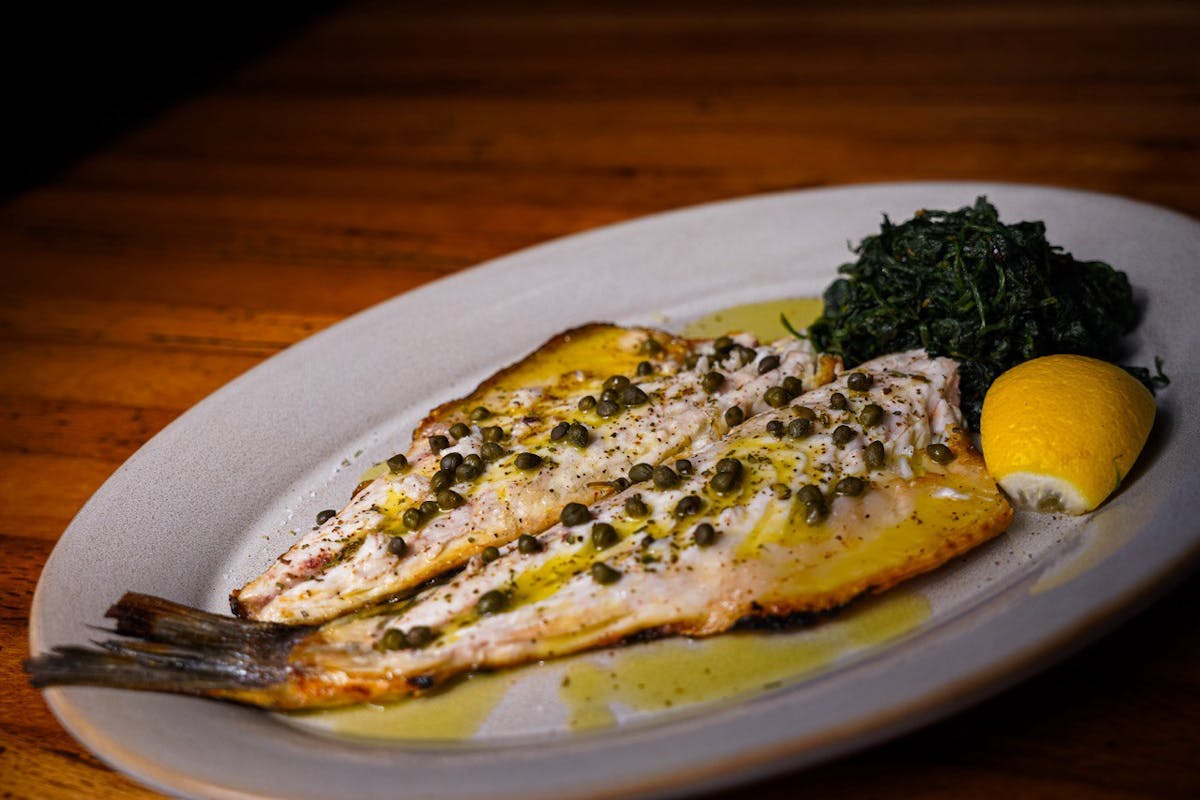 a plate of food sitting on top of a wooden table