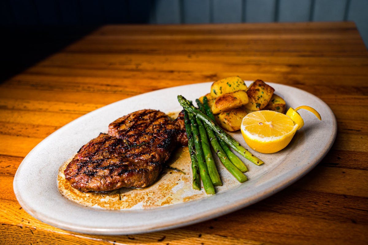 a plate of food sitting on top of a wooden table