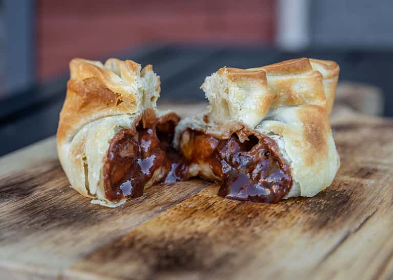 a close up of a sandwich sitting on top of a wooden table