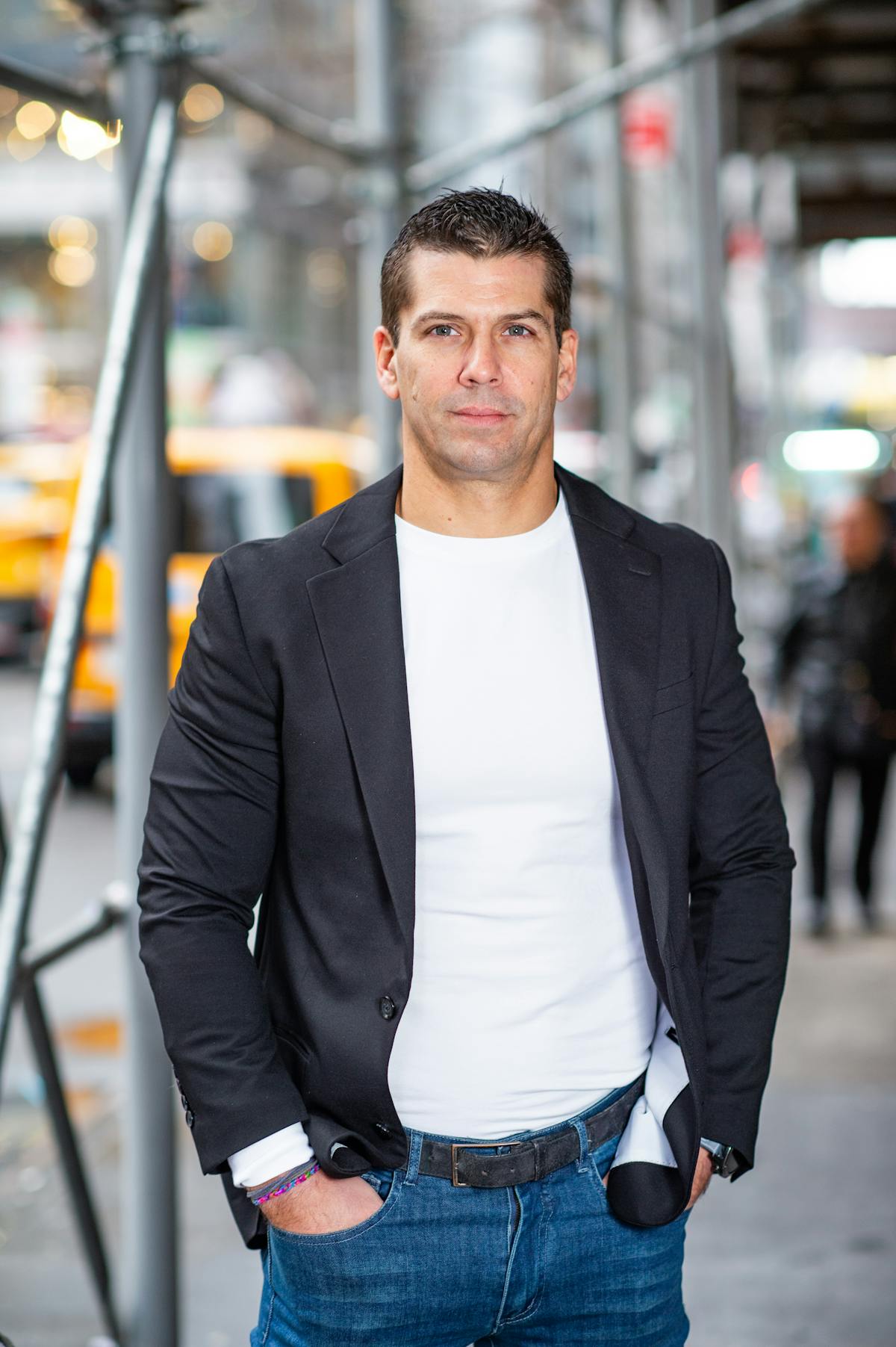 a man wearing a suit and tie walking down the street
