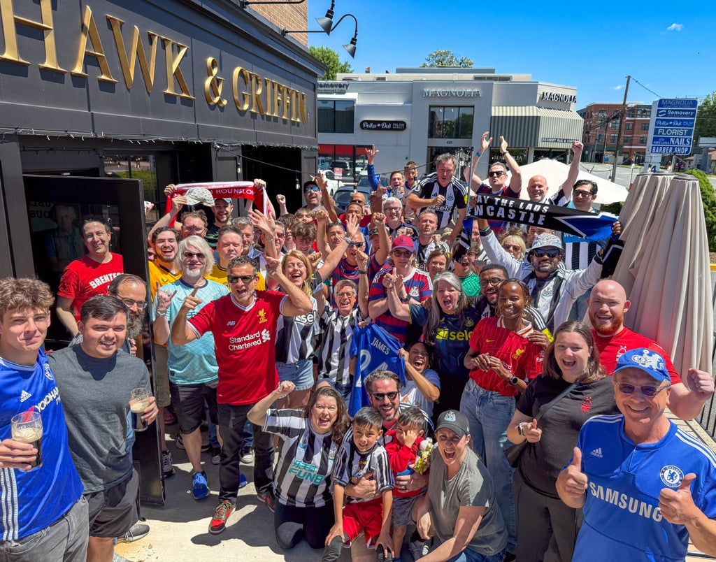 a group of people standing in front of a crowd posing for the camera