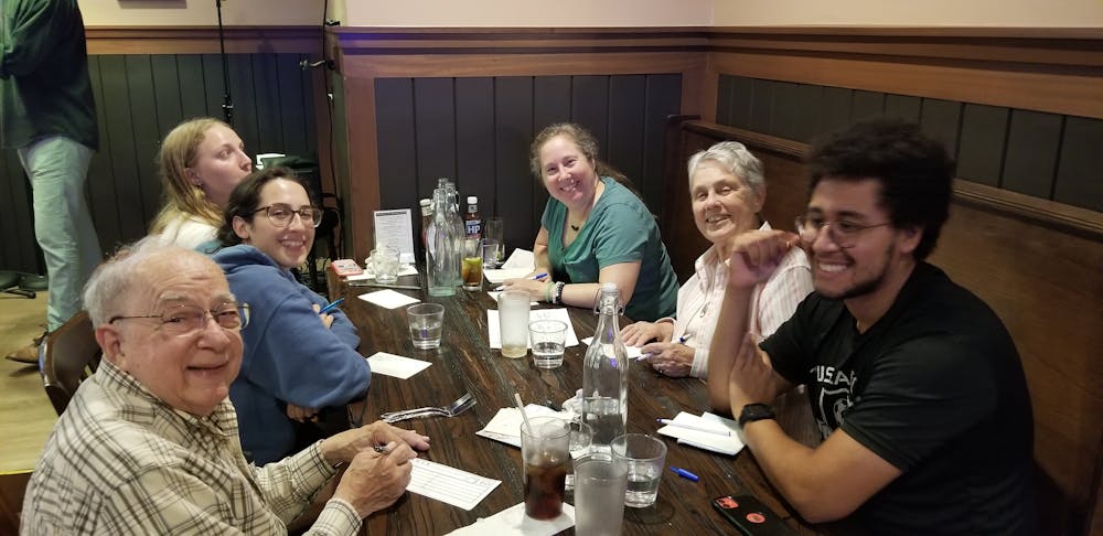 a group of people sitting at a table with wine glasses