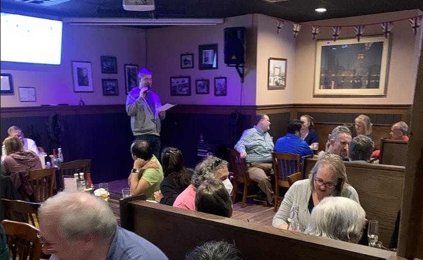a group of people sitting at a table in a restaurant