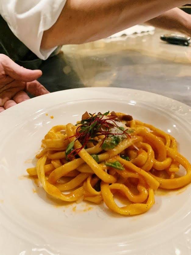 a plate of pasta with meat and vegetables