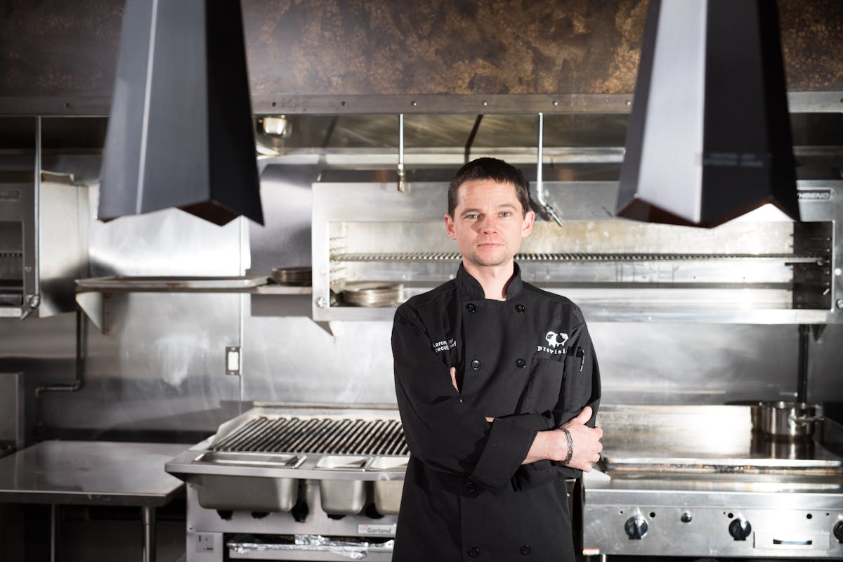 a person standing in front of a stove