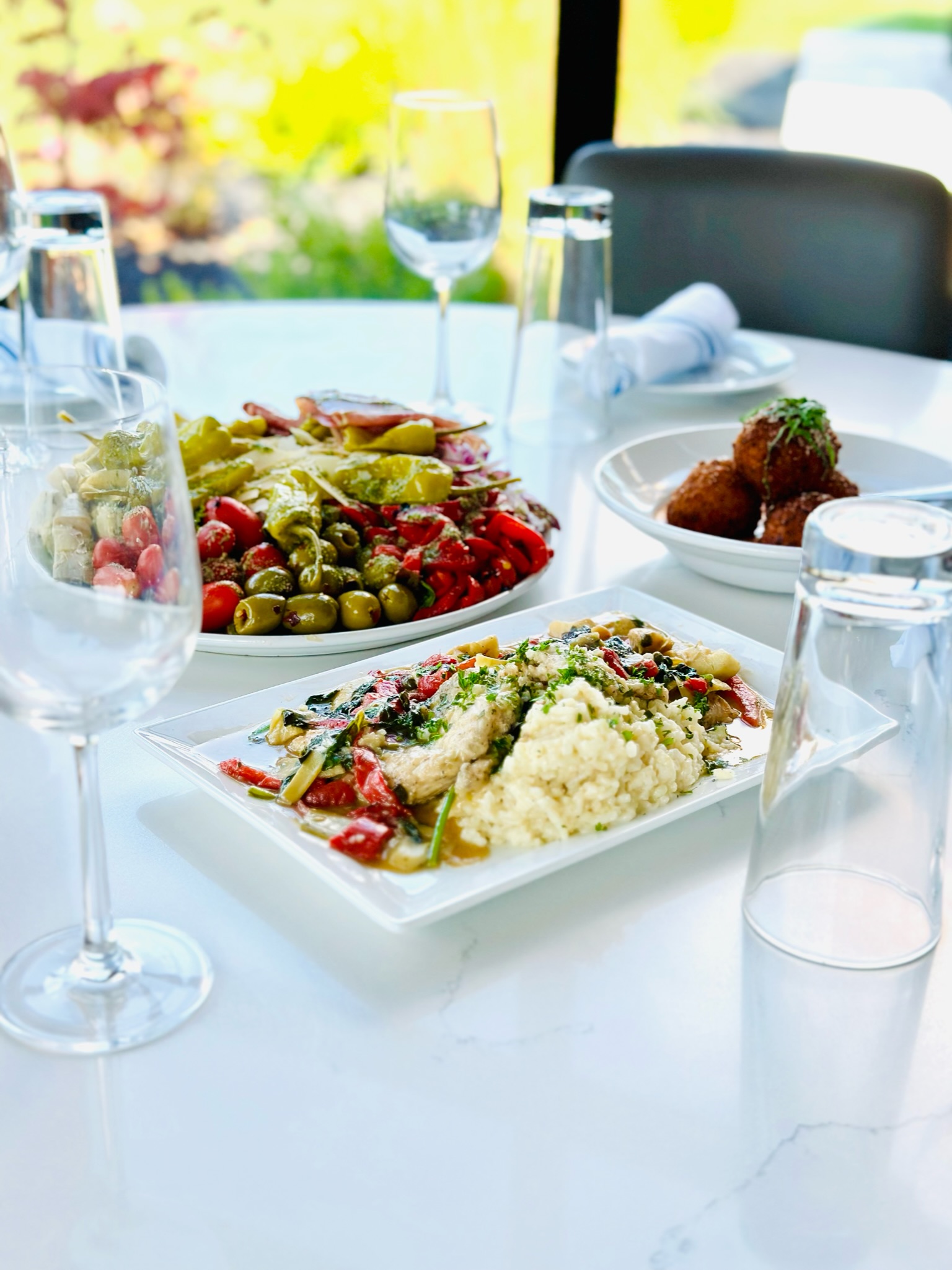 a plate of food and a glass of wine