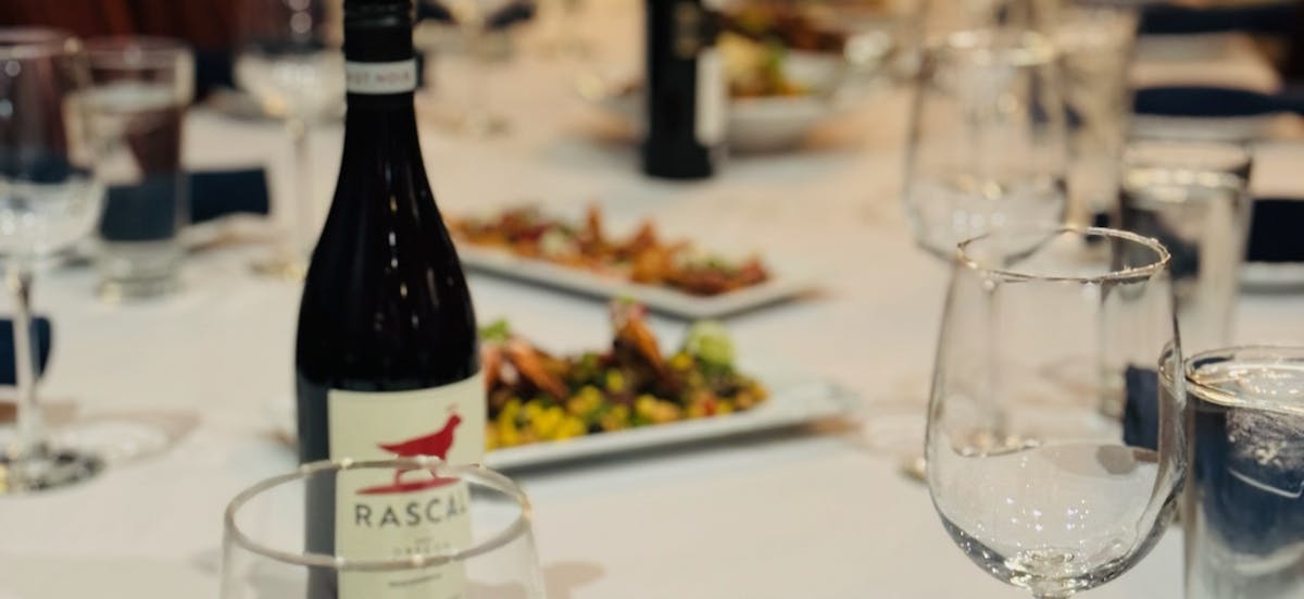 a close up of a bottle and a glass of wine