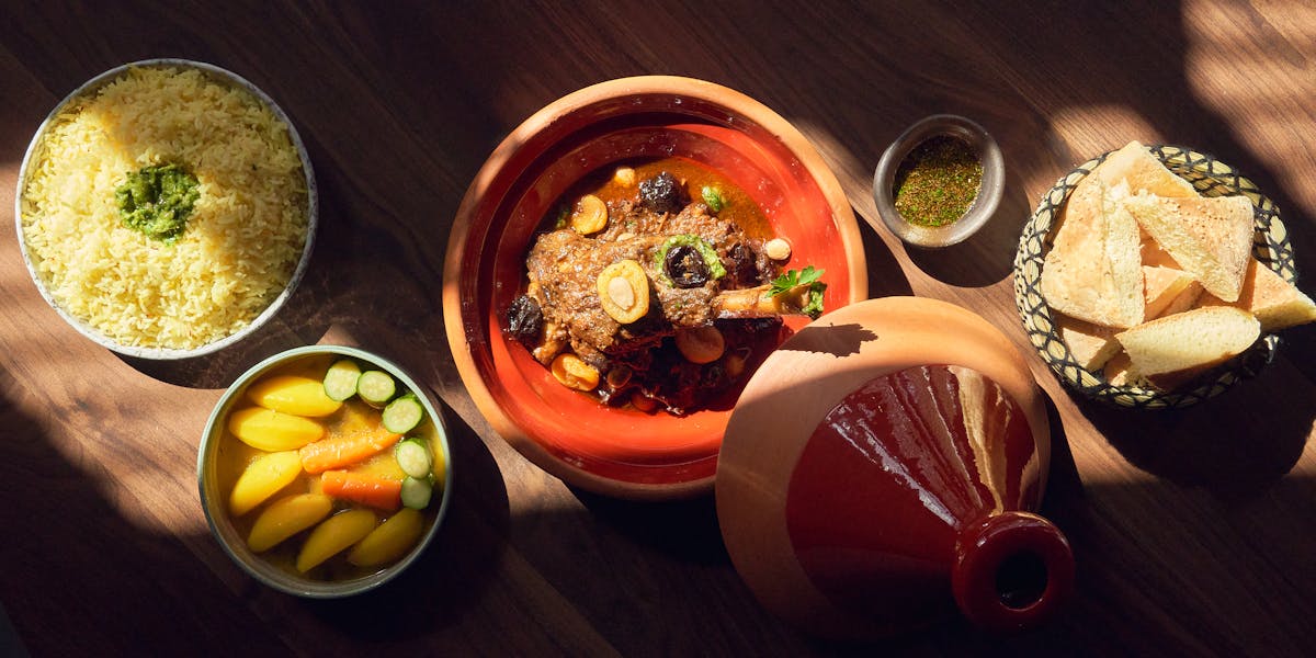 a bowl of food sitting on top of a wooden table