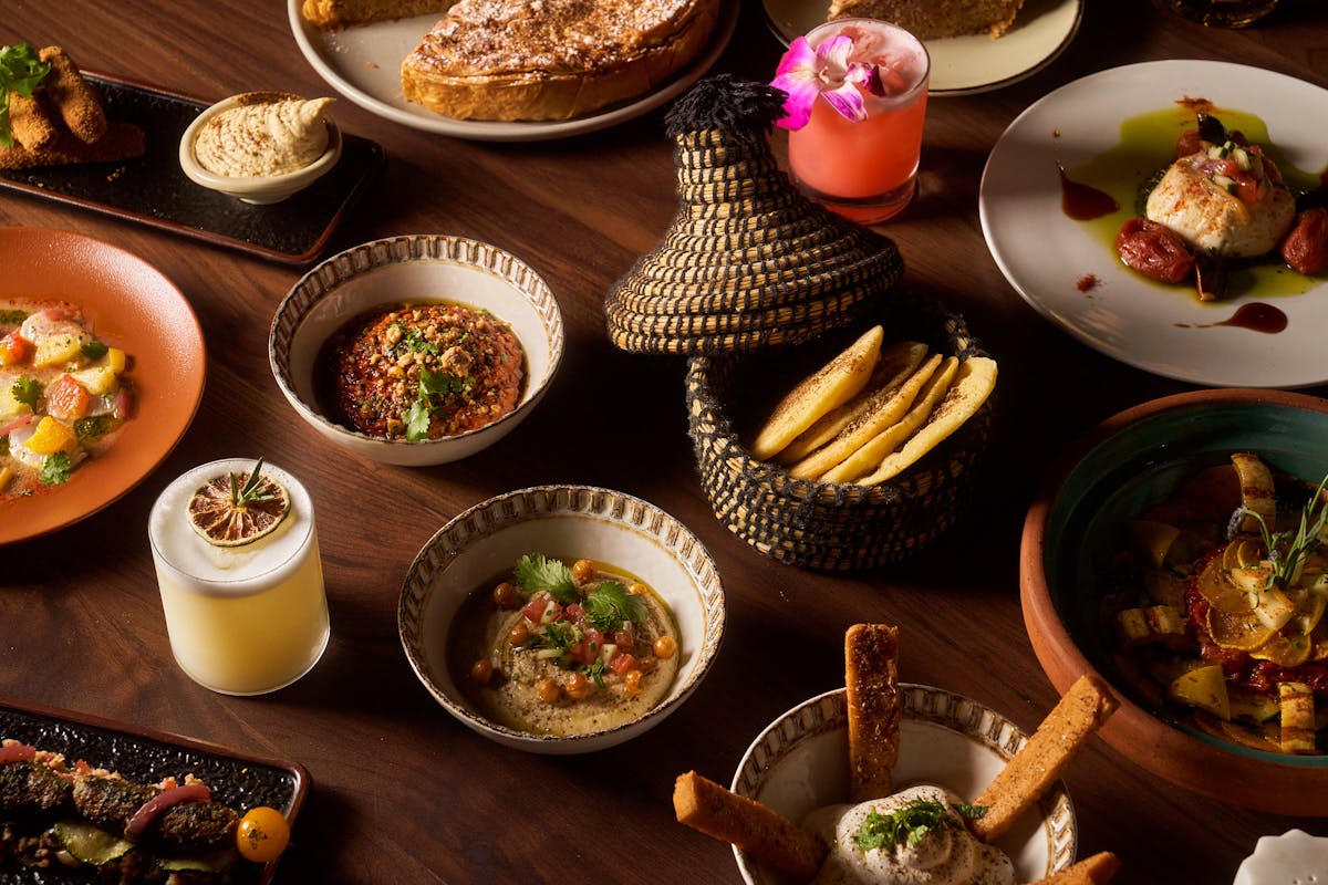 a bowl of food sitting on top of a wooden table