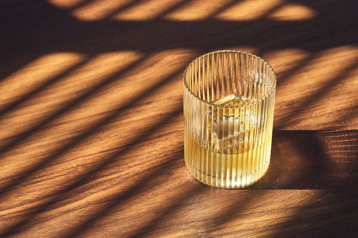 a transparent glass with beverage