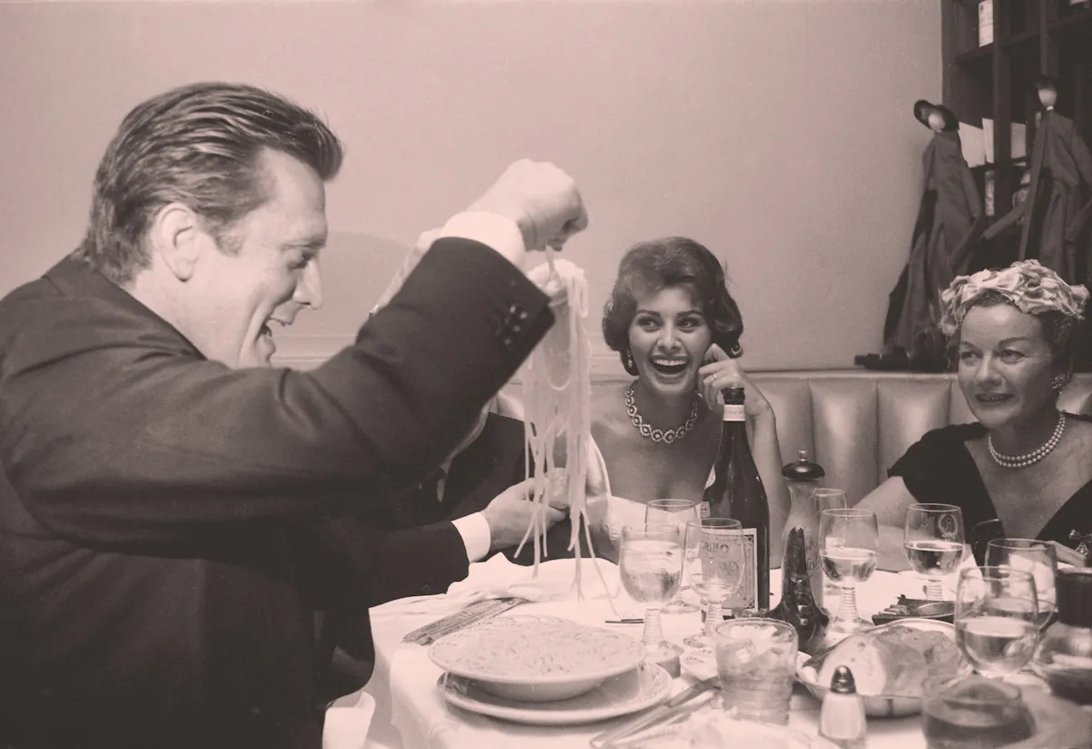 Sophia Loren et al. sitting at a table