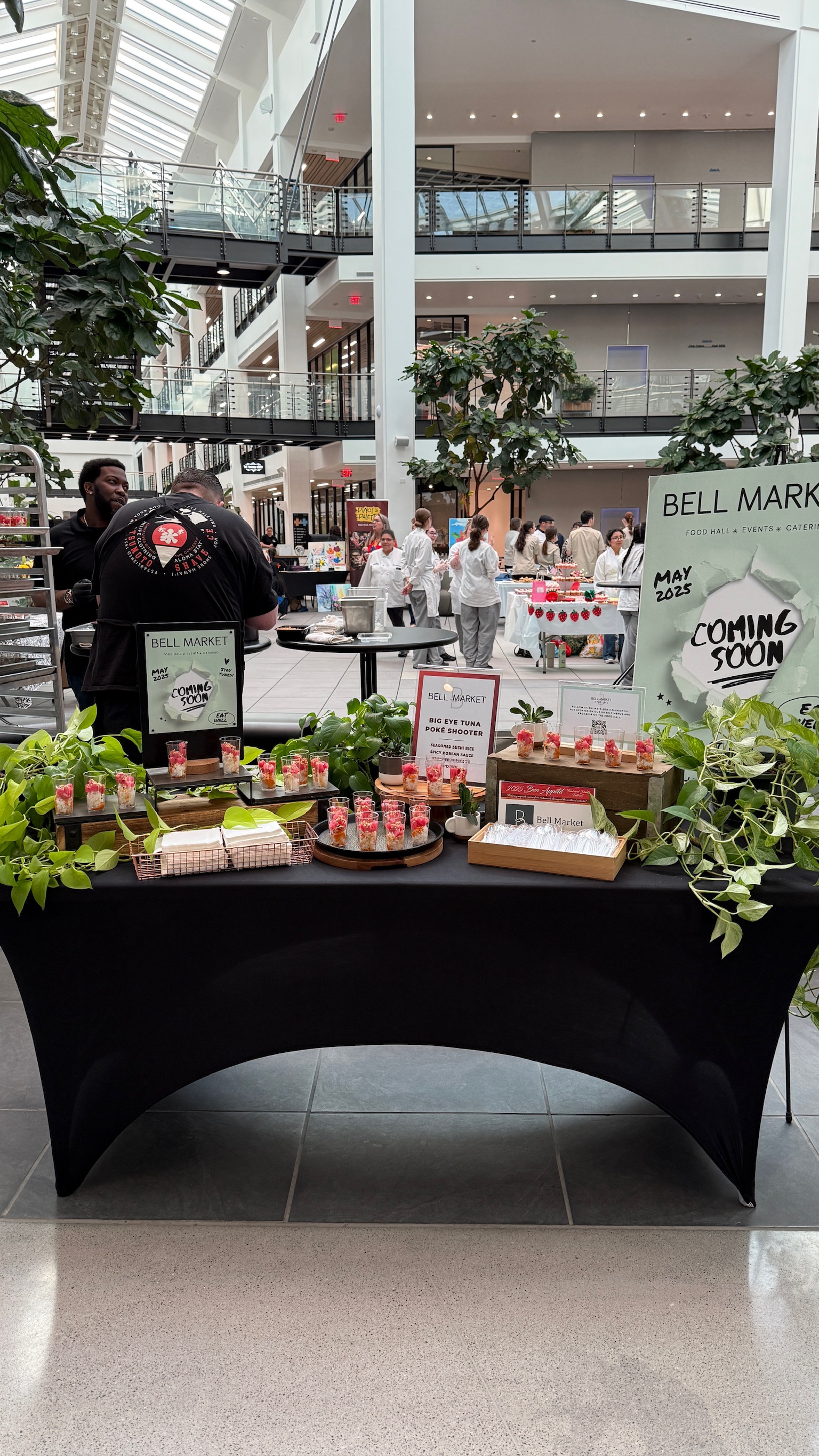a group of people sitting at a table in front of a building