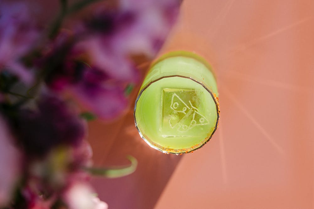 a person sitting at a table with wine glasses