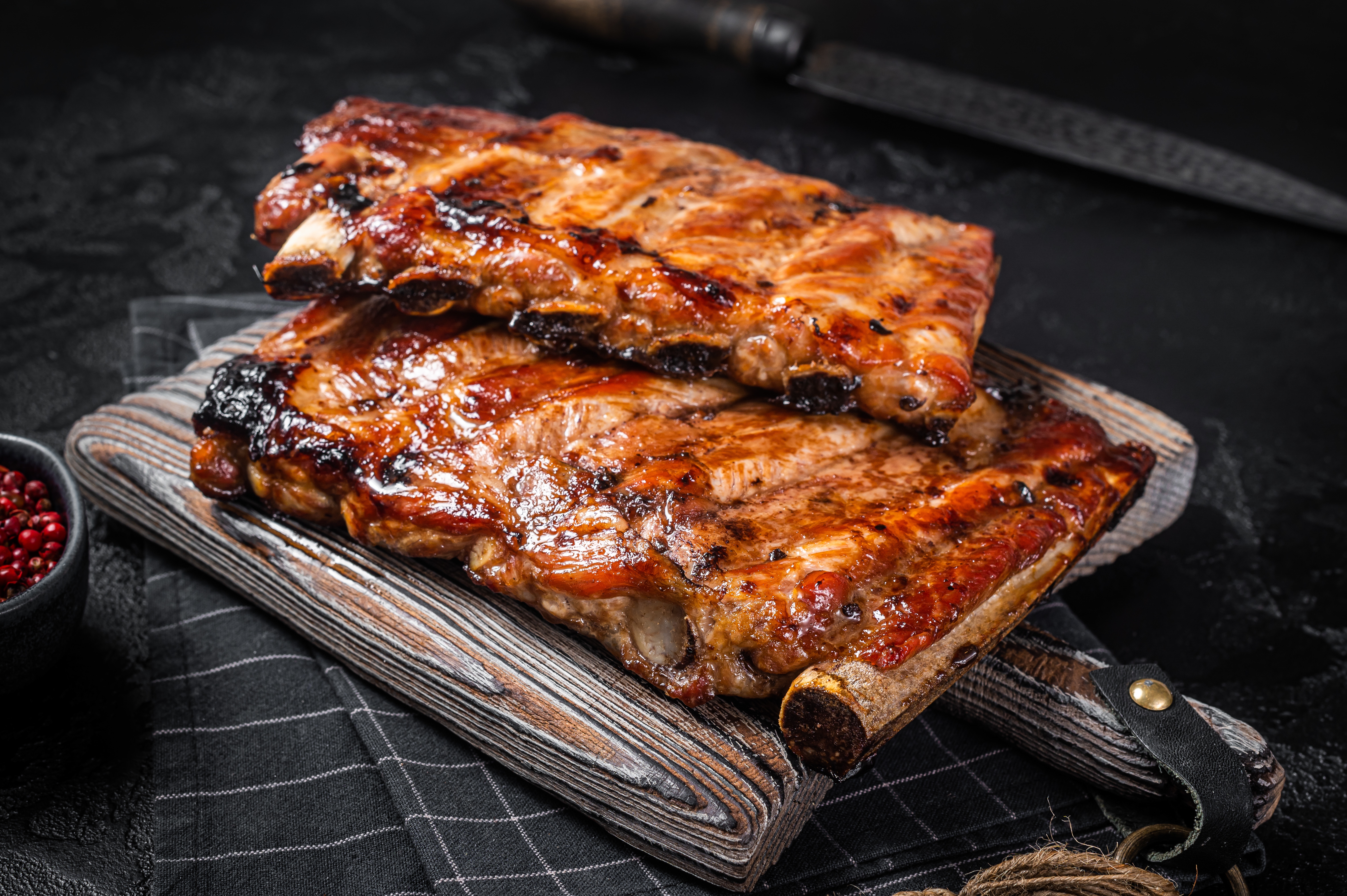 a slice of pizza sitting on top of a wooden cutting board