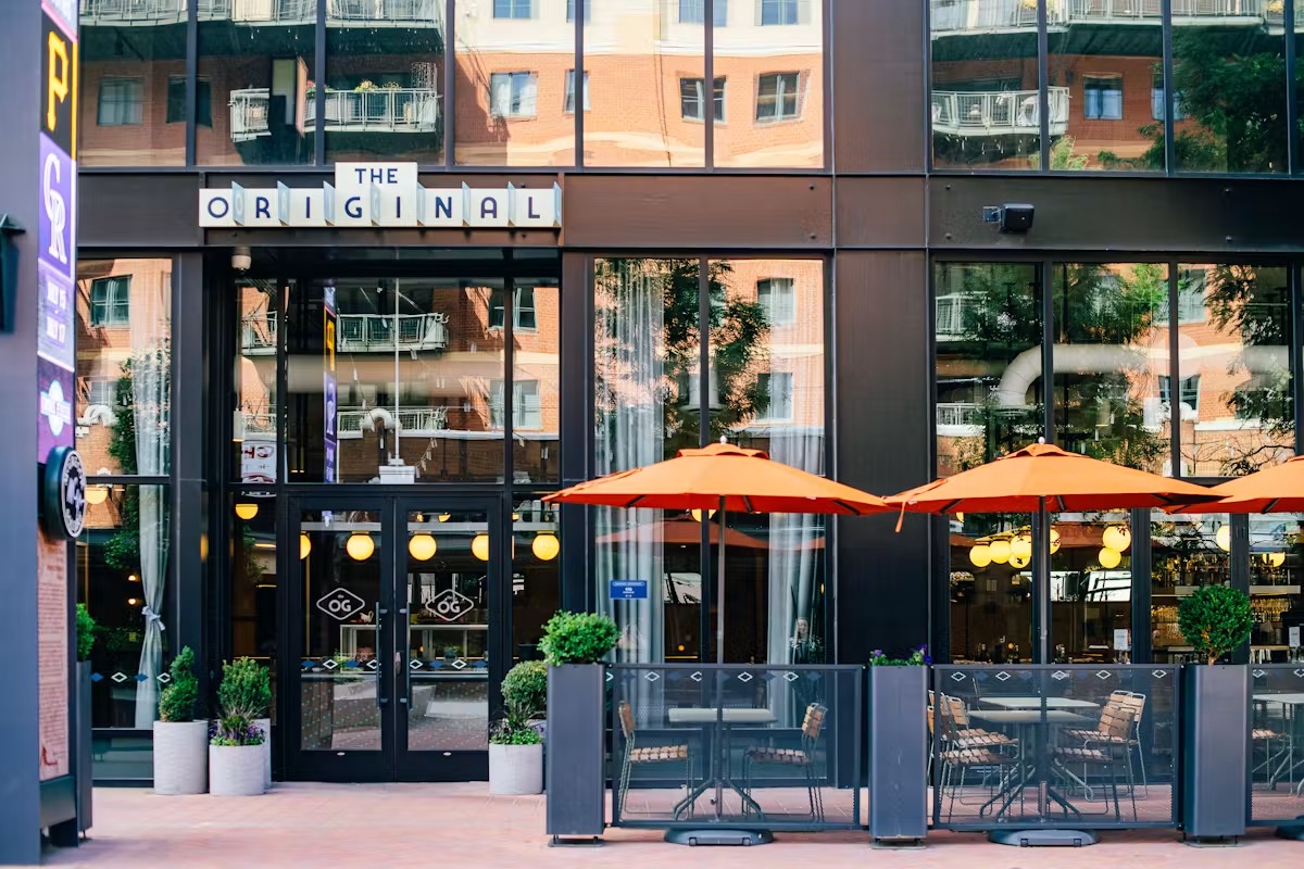 a building with glass windows and tables and chairs