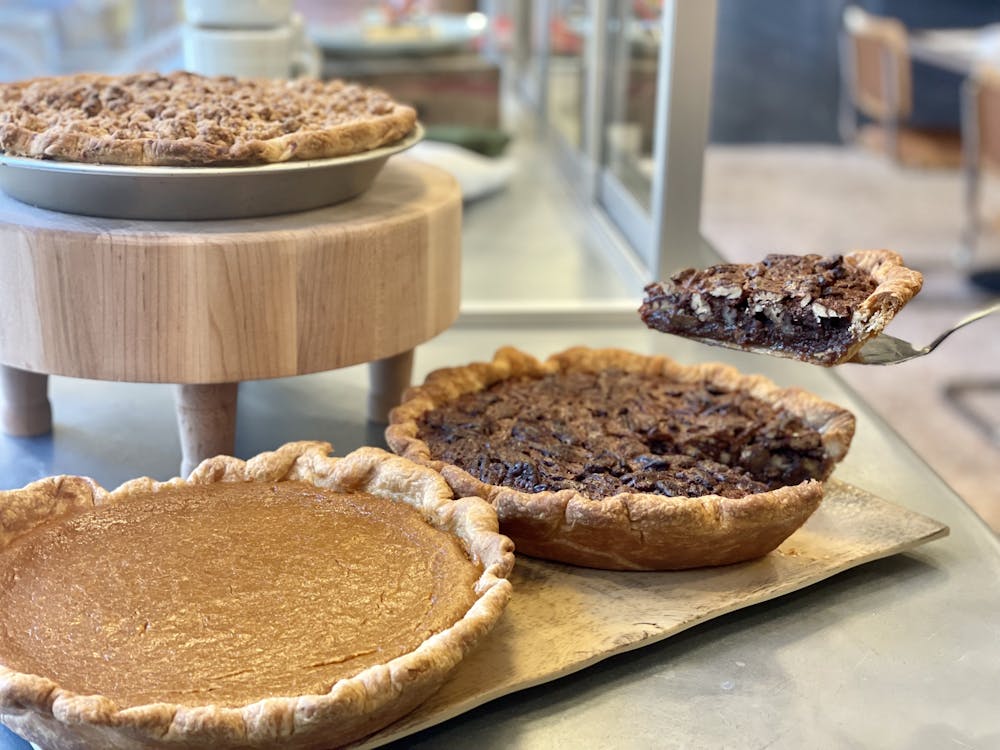 a plate of food that is on a cutting board with a cake
