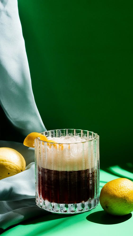 Large pitcher of batch fall rum cocktail with garnish