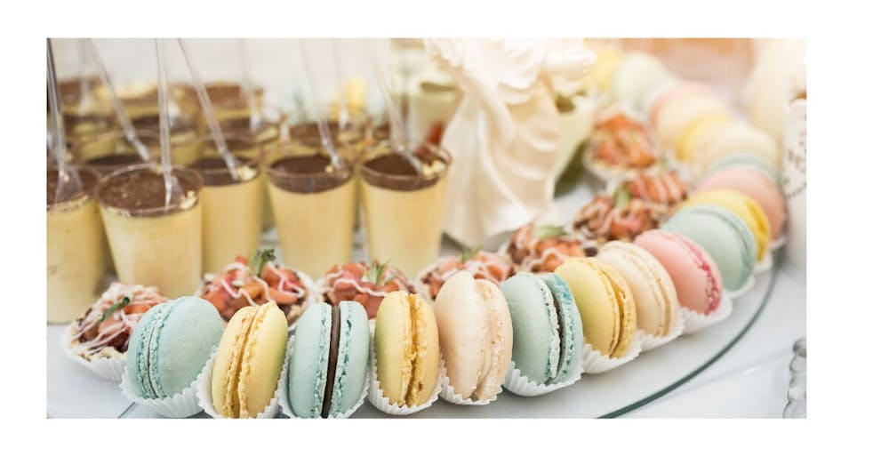 breakfast catering setup with yogurt parfaits, fruit, and pastries for office meeting