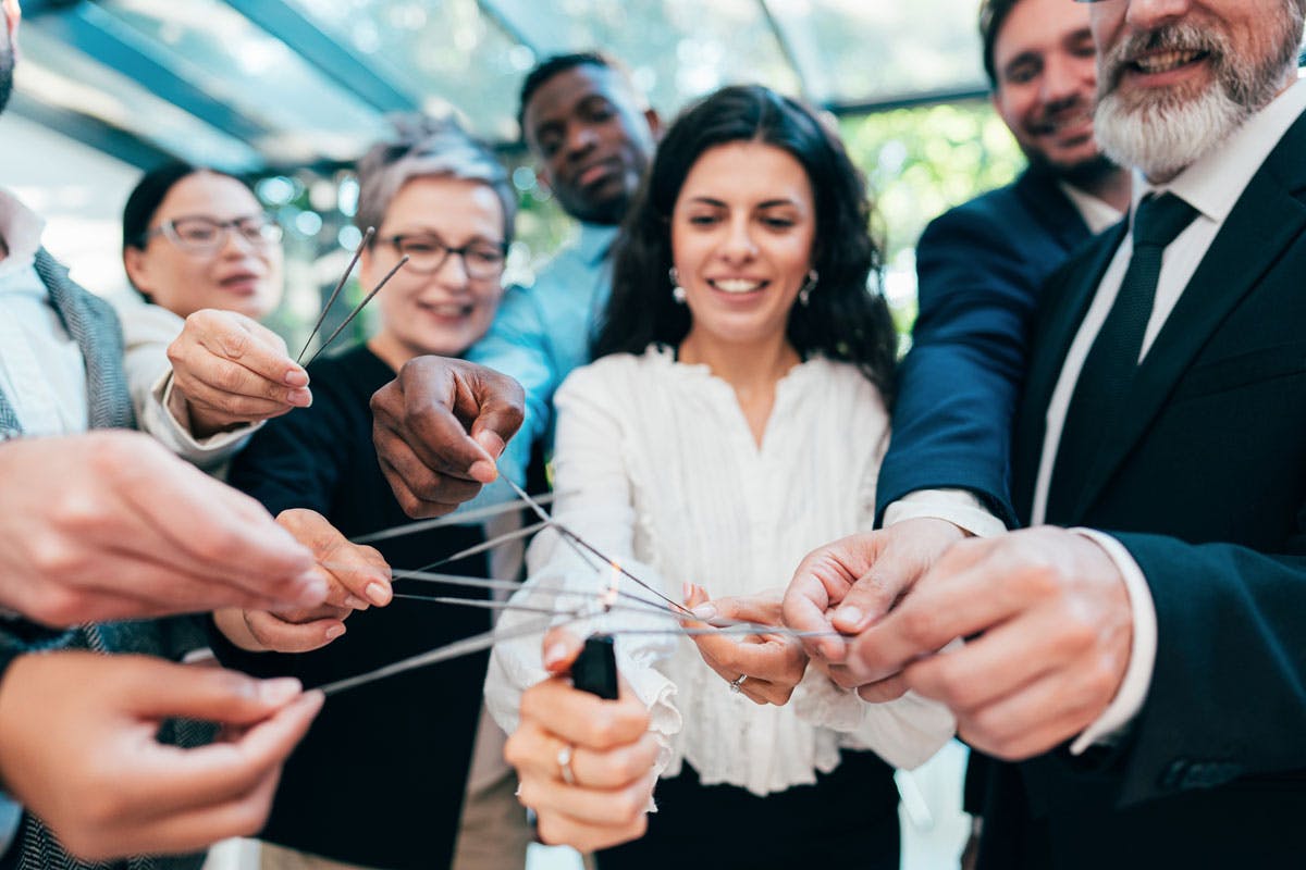 Employees lighting sparklers at a team building corporate event