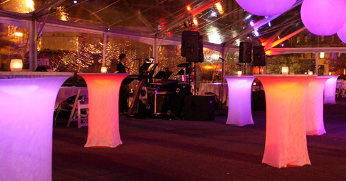 Event setup with glowing cocktail tables for vegan catering near Boca Raton