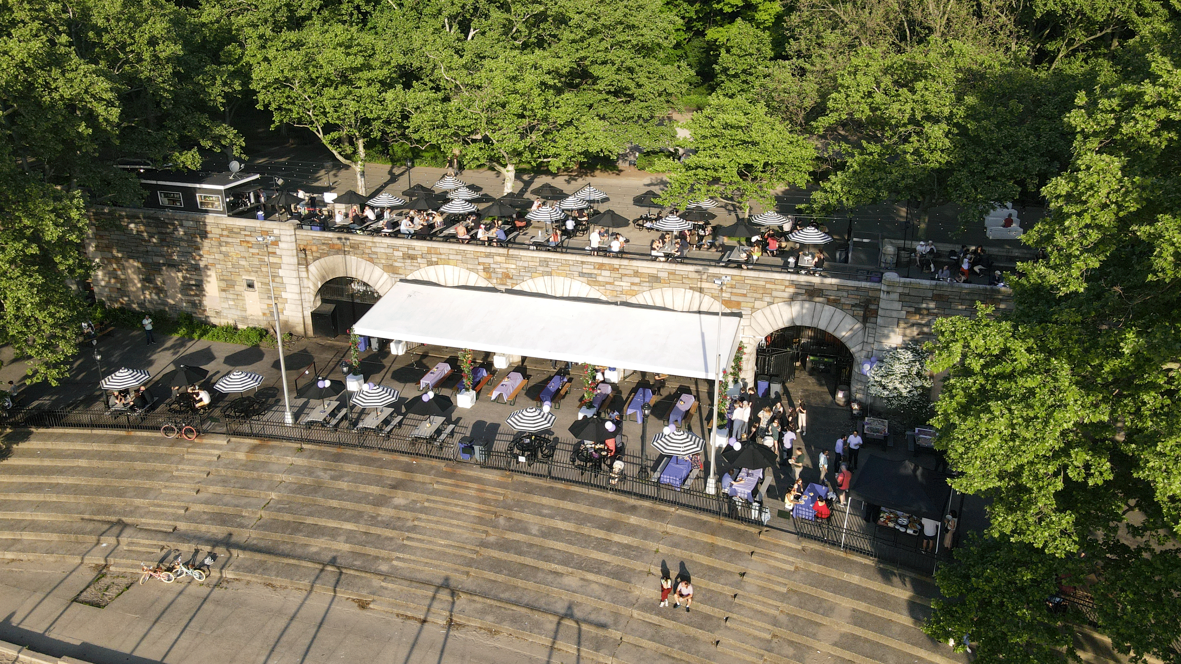 a group of people walking on a bridge