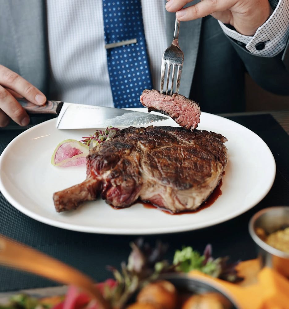 a woman sitting at a table with a plate of food