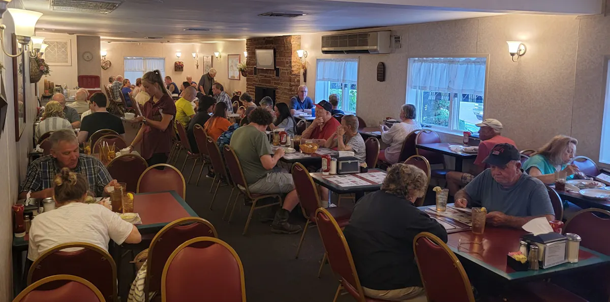 a group of people sitting at a table in a restaurant