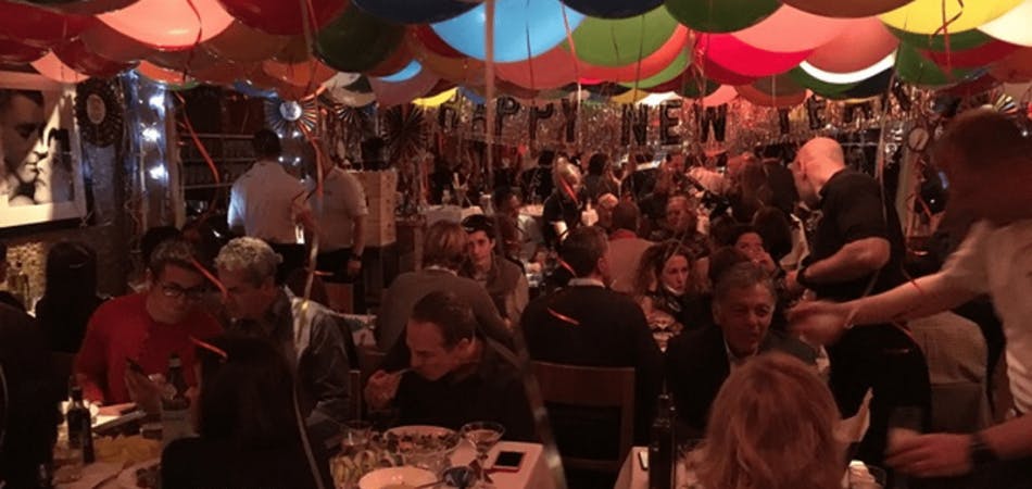 a group of people sitting at a table in a restaurant