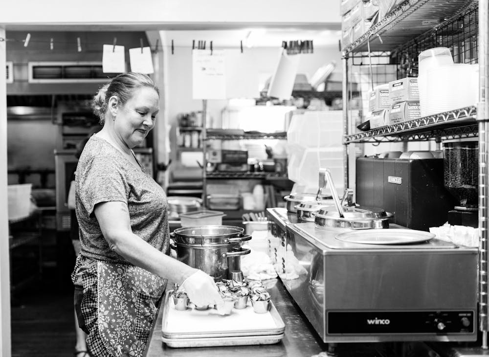 a person standing in a kitchen preparing food